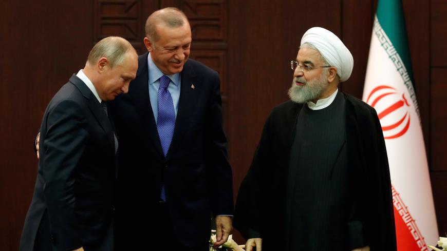 Presidents Vladimir Putin of Russia, Tayyip Erdogan of Turkey and Hassan Rouhani of Iran chat following a joint news conference in Ankara, Turkey, September 16, 2019. REUTERS/Umit Bektas - RC1EF10953B0
