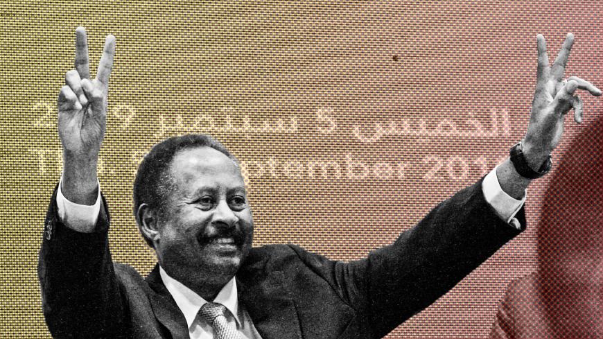 Sudan's new Prime Minister Abdalla Hamdok flashes the victory gesture during a press conference unveiling the first cabinet since veteran leader Omar al-Bashir's overthrow, in the capital Khartoum on September 5, 2019. - The announcement is a major step in the country's hard-won transition to civilian rule after decades of authoritarianism. It had been delayed for days as Hamdok mulled over the nominees proposed by the movement that led the months-long protests against Bashir and also the generals who ouste
