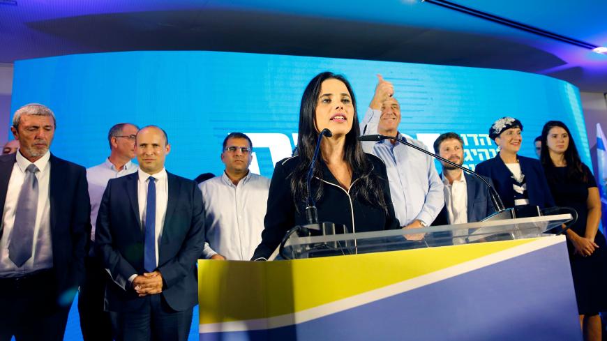 Ayelet Shaked (C), leader and candidate of the New Right party that is part of the Yamina political alliance, speaks while flanked by New Right party member and candidate Naftali Bennett (2nd-L) and Jewish Home party leader and candidate Rafi Peretz (L), at the alliance's headquarters in Ramat Gan, north of Tel Aviv, late on September 17, 2019, as the first exit polls are announced on television. - Israeli Prime Minister Benjamin Netanyahu and his main challenger Benny Gantz were neck-and-neck in the countr