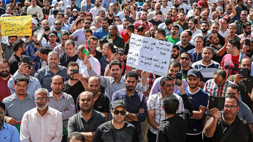 Public school teachers gather for a demonstration demanding pay raises, at the Professional Associations Complex in Jordan's capital Amman on October 3, 2019. (Photo by Khalil MAZRAAWI / AFP) (Photo by KHALIL MAZRAAWI/AFP via Getty Images)