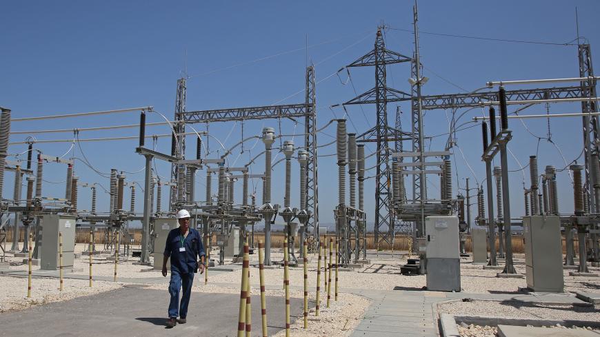 A worker walks at the site where a new electricity plant will be built in Jalamah, near the West Bank town of Jenin, following the signing of a new contract on July 10, 2017.
Israel Energy Minister Yuval Steinitz made a rare appearance by a high-ranking Israeli official in the occupied West Bank to sign the agreement on electricity with the Palestinian Authority. / AFP PHOTO / JAAFAR ASHTIYEH        (Photo credit should read JAAFAR ASHTIYEH/AFP via Getty Images)