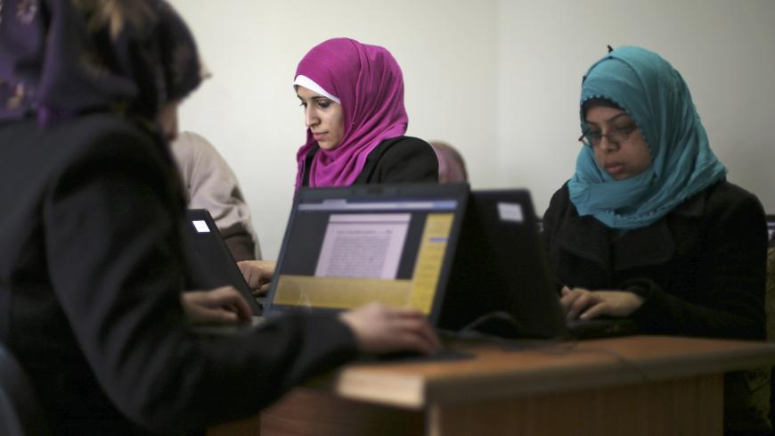 Palestinian employees process data on their laptops at Unit One in Gaza City January 15, 2015. In nine years, Gaza-based IT entrepreneur Saady Lozon and his partner Ahmed Abu Shaban have transformed their firm, Unit One, from a tiny outfit in a single room in the blockaded Gaza Strip into a successful business with clients in Europe, the United States and the Arab world. They can't leave Gaza easily, but they can develop applications for Web and mobile devices online and provide international clients with d