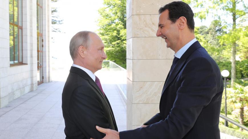 Russian President Vladimir Putin welcomes Syrian President Bashar al-Assad during their meeting in the Black Sea resort of Sochi, Russia May 17, 2018. Sputnik/Mikhail Klimentyev/Kremlin via REUTERS ATTENTION EDITORS - THIS IMAGE WAS PROVIDED BY A THIRD PARTY. - UP1EE5H1HAAE8