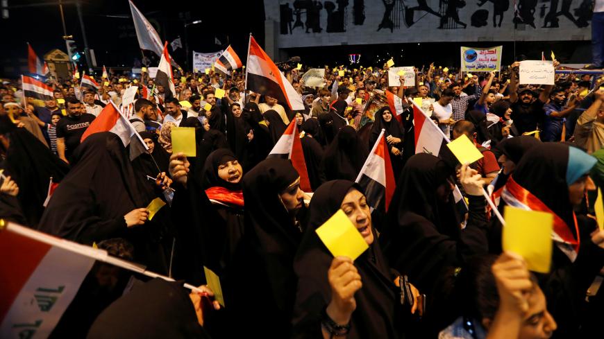 Supporters of Iraqi Shi'ite cleric Moqtada al-Sadr hold a yellow card which means the last warning, during a protest against the poor performance of parliament and government in Baghdad, Iraq, June 21, 2019. REUTERS/Khalid al-Mousily - RC1968D6E9D0