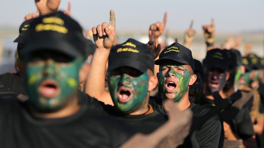 Young Palestinians have their faces painted as they chant slogans during a military-style graduation ceremony at a summer camp organised by Islamic Jihad, in Gaza City July 4, 2019.  REUTERS/Ibraheem Abu Mustafa - RC1549743970