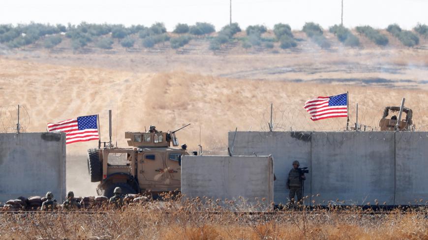 U.S. troops are seen behind the Turkish border walls during a joint U.S.-Turkey patrol in northern Syria, as it is pictured from near the Turkish town of Akcakale, Turkey, September 8, 2019. REUTERS/Murad Sezer - RC123ADD7730