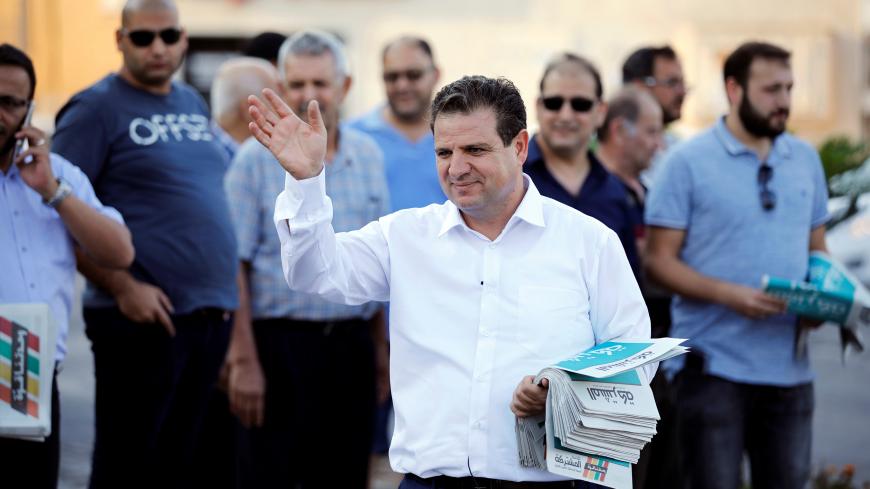 Ayman Odeh, leader of the Joint List, gestures as he hands out pamphlets during an an election campaign event in Tira, northern Israel September 5, 2019. Picture taken September 5, 2019. REUTERS/Amir Cohen - RC131423B620