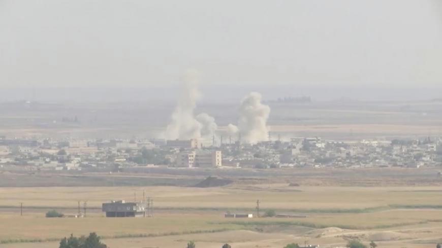 Smoke billows out after Turkish shelling on the Syrian border town of Ras Al Ain, as seen from Ceylanpinar, Turkey, October 11, 2019 in this still image taken from a video. REUTERS/ReutersTV - RC1DE85B2330