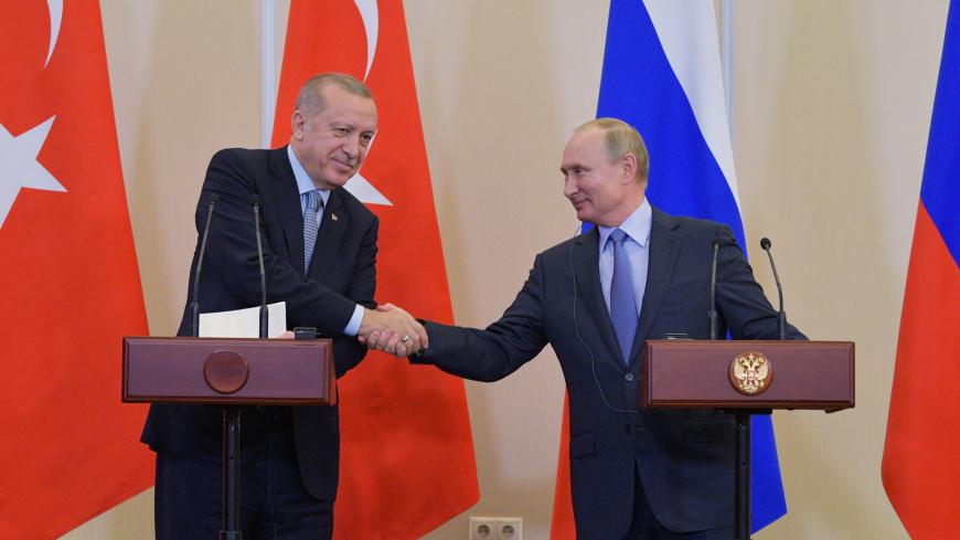 Russian President Vladimir Putin shakes hands with Turkish President Tayyip Erdogan during a news conference following their talks in Sochi, Russia October 22, 2019. Sputnik/Alexei Druzhinin/Kremlin via REUTERS  ATTENTION EDITORS - THIS IMAGE WAS PROVIDED BY A THIRD PARTY. - RC16F18BD6F0