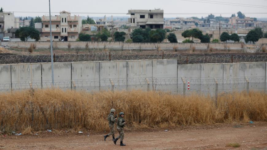 Turkish soldiers patrol along a wall on the border line between Turkey and Syria, in the Turkish border town of Ceylanpinar, in Sanliurfa province, Turkey, October 29, 2019. REUTERS/Kemal Aslan - RC1AB07BD360