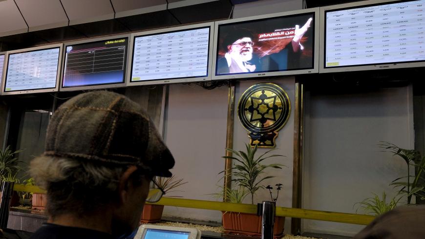 An investor looks at a tablet supplying stock market information about listed companies on the Tehran stock exchange in Tehran, Iran, January 17, 2016. REUTERS/Raheb Homavandi/TIMAATTENTION EDITORS - THIS IMAGE WAS PROVIDED BY A THIRD PARTY. FOR EDITORIAL USE ONLY.  - GF20000097649