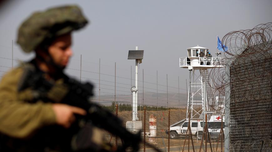 An Israeli soldier stands near the Quneitra crossing in the Golan Heights on the border line between Israel and Syria, October 15, 2018. REUTERS/Amir Cohen - RC1FD4BF4A00