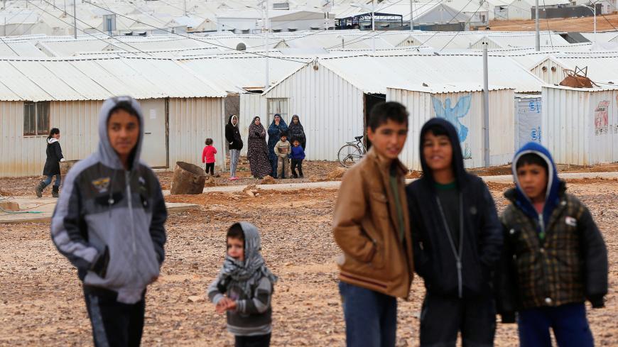 Syrian refugees look at the camera as they stand in front of their homes at Azraq refugee camp, near Al Azraq city, Jordan, December 8, 2018. REUTERS/Muhammad Ham - RC1ACC4C9FD0