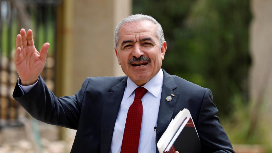 Palestinian Prime Minister Mohammad Shtayyeh gestures as he arrives for a cabinet meeting of the new Palestinian government, in Ramallah, in the Israeli-occupied West Bank April 15, 2019. REUTERS/Mohamad Torokman - RC17C1961100