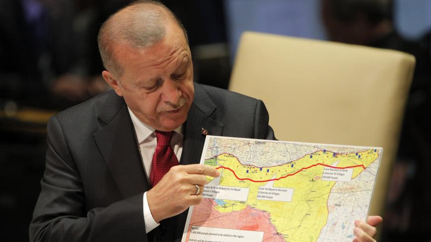 Turkey's President Recep Tayyip Erdogan holds up a map as he addresses the 74th session of the United Nations General Assembly at U.N. headquarters in New York City, New York, U.S., September 24, 2019. REUTERS/Brendan Mcdermid - HP1EF9O181E99