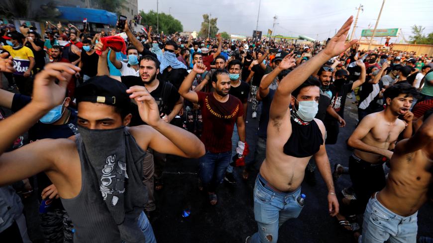 Demonstrators gesture at a protest over unemployment, corruption and poor public services, in Baghdad, Iraq October 2, 2019. REUTERS/Thaier al-Sudani - RC14FB3AD990