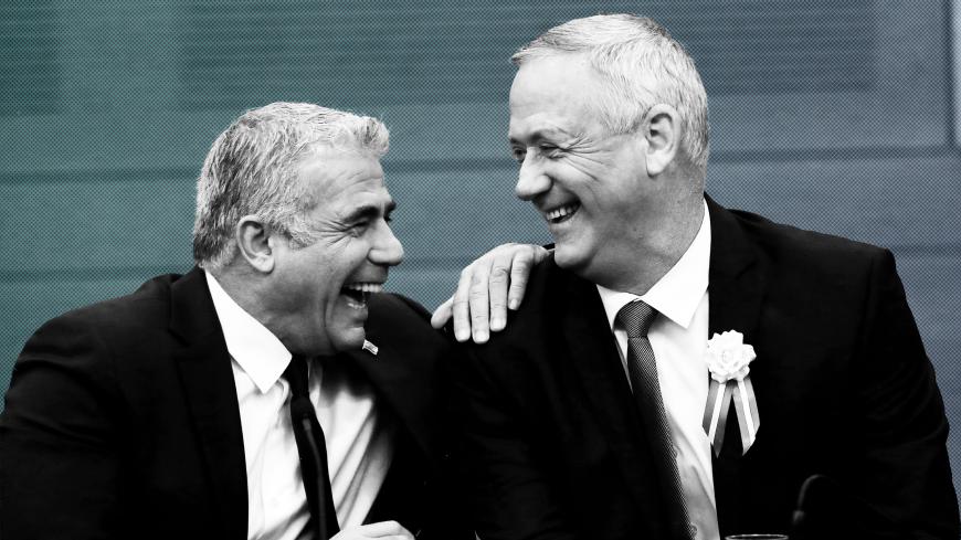 Benny Gantz, leader of Blue and White, and party member Yair Lapid chat during their party faction meeting at the Knesset, Israel's parliament, in Jerusalem October 3, 2019. REUTERS/Ronen Zvulun - RC19B4385D20