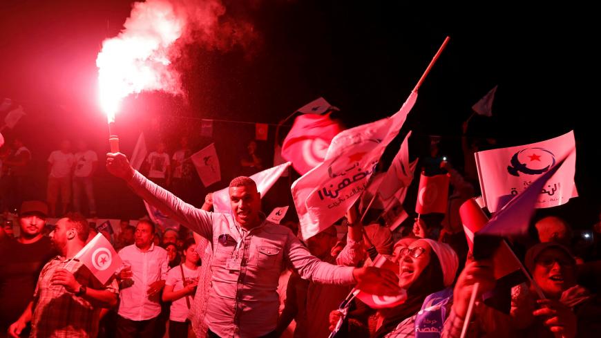 Supporters of Tunisia's moderate Islamist Ennahda party celebrate, after the party gained most votes in Sunday's parliamentary election, according to an exit poll by Sigma Conseil broadcasted by state television, in Tunis, Tunisia October 6, 2019. REUTERS/Zoubeir Souissi - RC1569FBC4D0