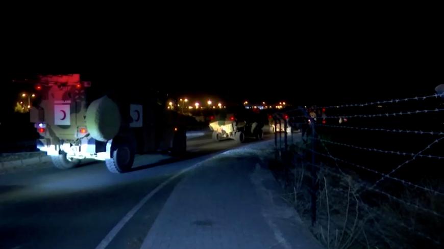 A Turkish armored military convoy is seen driving along the border with Syria, in Akcakale, Turkey October 9, 2019 in this still image obtained from video. REUTERS TV via REUTERS - RC1D52FA41D0