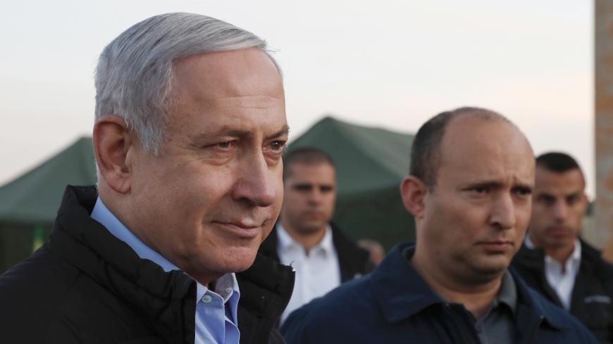 Israel's Prime Minister Benjamin Netanyahu (L) and Defence Minister Naftali Bennett (2nd) visit an army base in the Israeli-annexed Golan Heights overlooking Syrian territory, on November 24, 2019. (Photo by ATEF SAFADI / POOL / AFP) (Photo by ATEF SAFADI/POOL/AFP via Getty Images)