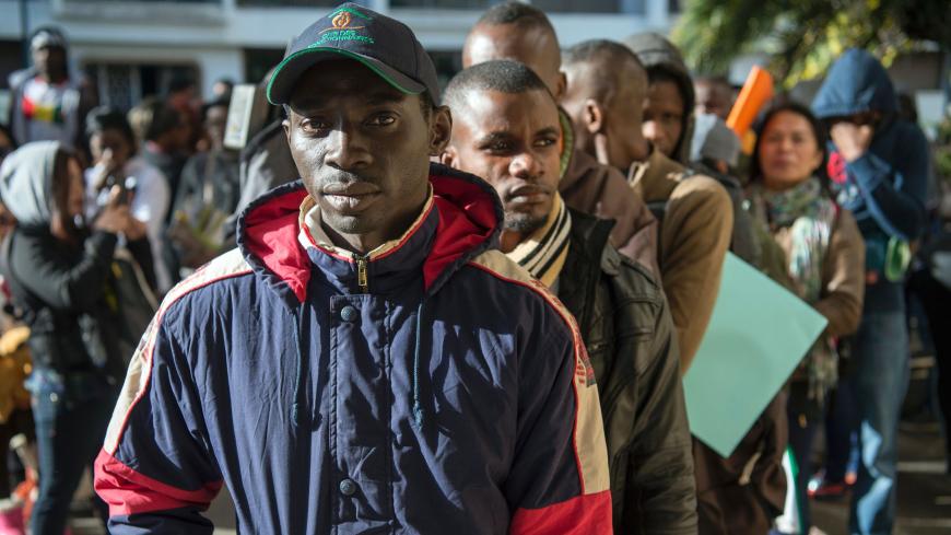 Migrants queue in line, during the second phase of a campaign to regularize illegal migrants living in Morocco, in Rabat, on December 15, 2016. / AFP / FADEL SENNA        (Photo credit should read FADEL SENNA/AFP via Getty Images)