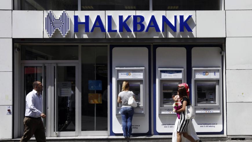 A customer (C) uses an automated teller machine at a branch of Halkbank in Istanbul August 15, 2014. Turkey's state-run lender Halkbank said on Friday it has offer to buy a 76.76 percent stake in Serbian lender Cacanska Banka for an undisclosed sum. Halkbank offered no further details on the potential acquisition in a statement to the Istanbul stock exchange. REUTERS/Osman Orsal (TURKEY - Tags: BUSINESS) - GM1EA8F1MZB01