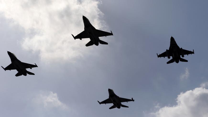 Jordanian F-16 fighter jets escorting the plane carrying Bahrain's King Hamad bin Isa Al Khalifa (not pictured) are seen at Amman airport February 9, 2015. REUTERS/Muhammad Hamed (JORDAN - Tags: POLITICS ROYALS MILITARY) - GM1EB2A01ND01