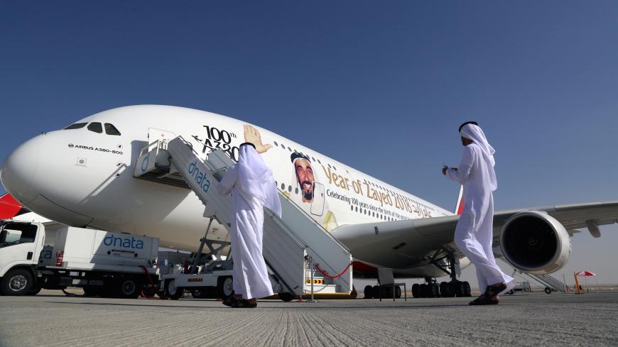 Visitors walk next to an Airbus A380, showing a picture of United Arab Emirates's Former President Sheikh Zayed bin Sultan al-Nahayan during the Dubai Airshow in Dubai, United Arab Emirates November 13, 2017. REUTERS/Satish Kumar - RC131063B650