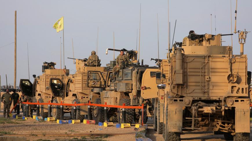 American soldiers stand near military trucks, at al-Omar oil field in Deir Al Zor, Syria March 23, 2019. REUTERS/Rodi Said - RC168E86AEF0