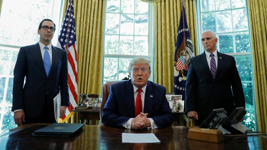 U.S.  President Donald Trump speaks before signing an executive order imposing fresh sanctions on Iran as Treasury Secretary Steven Mnuchin and Vice President Mike Pence look on in the Oval Office of the White House in Washington, U.S., June 24, 2019. REUTERS/Carlos Barria - RC1D3FDB52D0