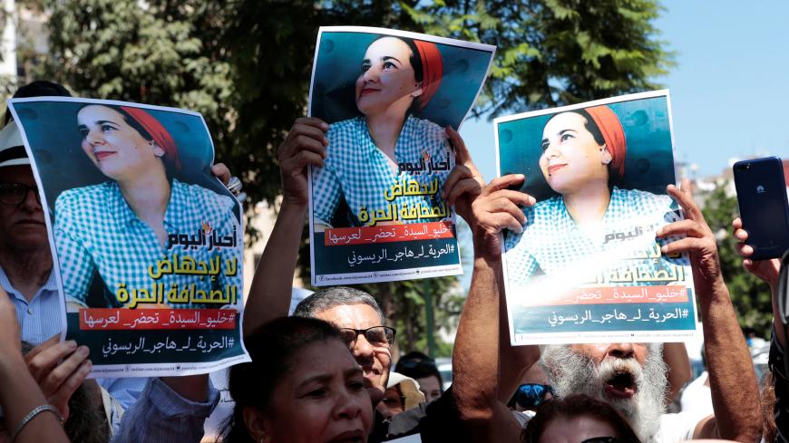 Moroccan activists hold the poster of Hajar Raissouni, a journalist charged with fornication and abortion, during a protest outside the Rabat tribunal, Morocco September 9, 2019. REUTERS/Youssef Boudlal - RC16585AAC30