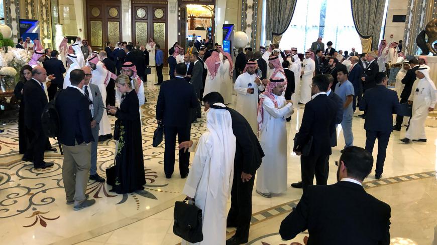 Participants take a break during the Future Investment Initiative conference in Riyadh, Saudi Arabia, October 30, 2019. REUTERS/Hamad I Mohammed - RC1CBAA19E30