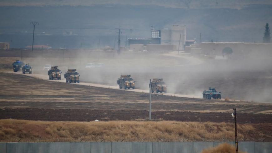 Turkish and Russian military vehicles return following a joint patrol in northeast Syria, as they are pictured from near the Turkish border town of Kiziltepe in Mardin province, Turkey, November 1, 2019. REUTERS/Kemal Aslan - RC1A4E403CD0