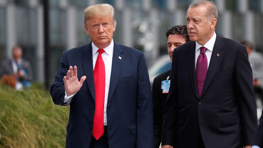 U.S. President Donald Trump and Turkish President Tayyip Erdogan attend the start of the NATO summit in Brussels, Belgium July 11, 2018.  REUTERS/Kevin Lamarque - RC117DD2EDF0