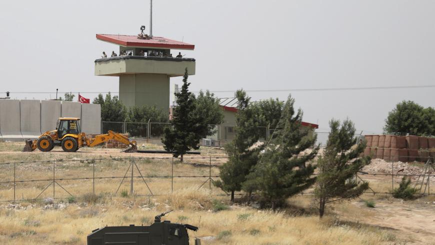 Turkish soldiers stand on a watch tower at the Atmeh crossing on the Syrian-Turkish border, as seen from the Syrian side, in Idlib governorate, Syria May 31, 2019. REUTERS/Khalil Ashawi - RC1525F30880
