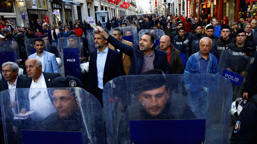Pro-Kurdish Peoples' Democratic Party (HDP) lawmakers walk along Istiklal Street as they are surrounded by riot police during an event to announce their upcoming party congress, in Istanbul, Turkey November 2, 2019. REUTERS/Huseyin Aldemir - RC1E16E1C7F0