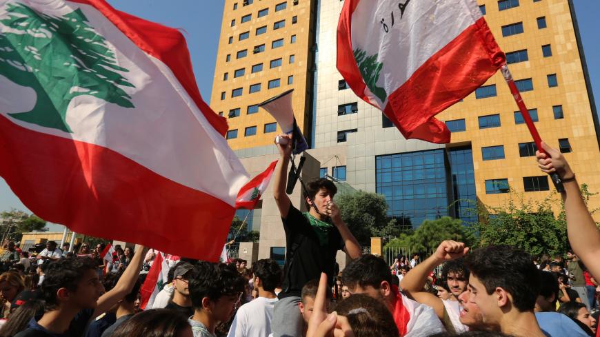 Students carry Lebanese flags during ongoing anti-government protests near the Ministry of Education and Higher Education in Beirut, Lebanon November 7, 2019. REUTERS/Aziz Taher - RC2D6D999YE7