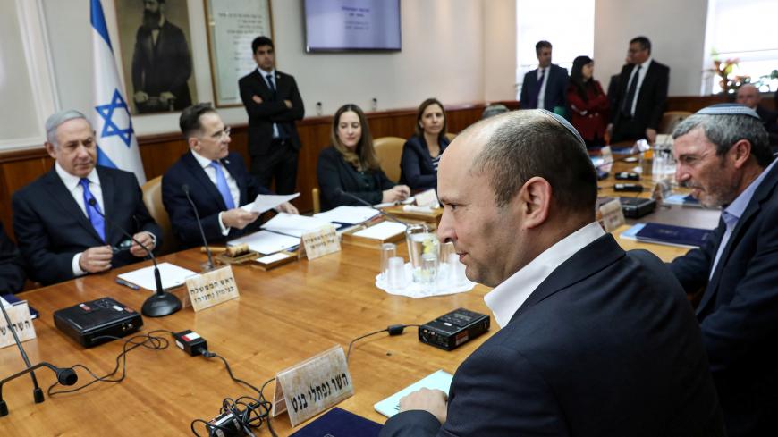 Israeli Prime Minister Benjamin Netanyahu looks at his new Defence Minister Naftali Bennett (2nd-R, front) at the start of the weekly cabinet meeting at his Jerusalem office on November 17, 2019. Gali Tibbon/Pool via REUTERS - RC2YCD90F72M