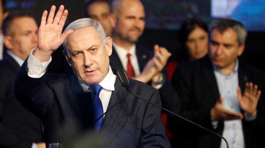 Israeli Prime Minister Benjamin Netanyahu waves after addressing members of his right-wing party bloc at a conference in Tel Aviv, Israel November 17, 2019. REUTERS/Nir Elias - RC26DD9NFJ8W