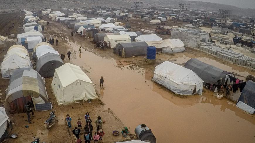 IDLIB, SYRIA - DECEMBER 13: A drone photo shows an aerial view of the mud covered road and tents at a refugee camp, where Syrian refugees live, after heavy rain at winter season in northeastern Idlib, Syria on December 13, 2019. Syrian refugees, who have been living in the camp, face flooding, mud and puddles due to lack of infrastructure and sewerage network. (Photo by Muhammed Said/Anadolu Agency via Getty Images)
