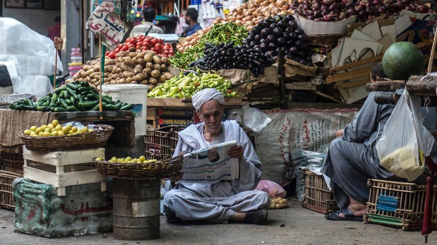 An Egyptian vendor reads the newspaper outside his fruit and vegetable stand in Egyptians in the Egyptian capital, Cairo, on May 15, 2017.
Ramadan is a time for daytime fasting and lavish evening feasts, but Egyptians are scaling back preparations for the Muslim holy month this year after austerity measures fuelled decades-high inflation. / AFP PHOTO / KHALED DESOUKI        (Photo credit should read KHALED DESOUKI/AFP via Getty Images)