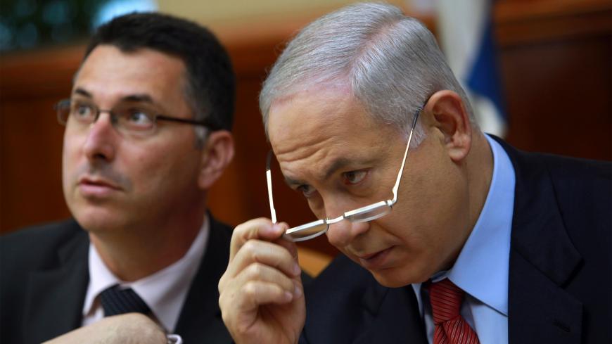 JERUSALEM, ISRAEL - OCTOBER 18: Israeli Prime Minister Benjamin Netanyahu looks over his glasses as he and Education Minister Gidon Sa'ar chat at the start of the weekly cabinet meeting October 18, 2009 in Jerusalem. The cabinet have rejected a UN Human Rights Council endorsement of the Goldstone report on the Israeli campaign in Gaza as unacceptable. (Photo by David Silverman/Getty Images)