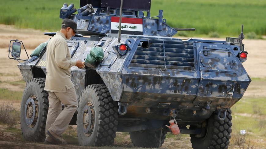 Iranian Revolutionary Guard Commander Qassem Soleimani walks near an armoured vehicle at the frontline during offensive operations against Islamic State militants in the town of Tal Ksaiba in Salahuddin province March 8, 2015. Picture taken March 8, 2015.   REUTERS/Stringer (IRAQ - Tags: CIVIL UNREST CONFLICT POLITICS) - GM1EB3I1GNY01