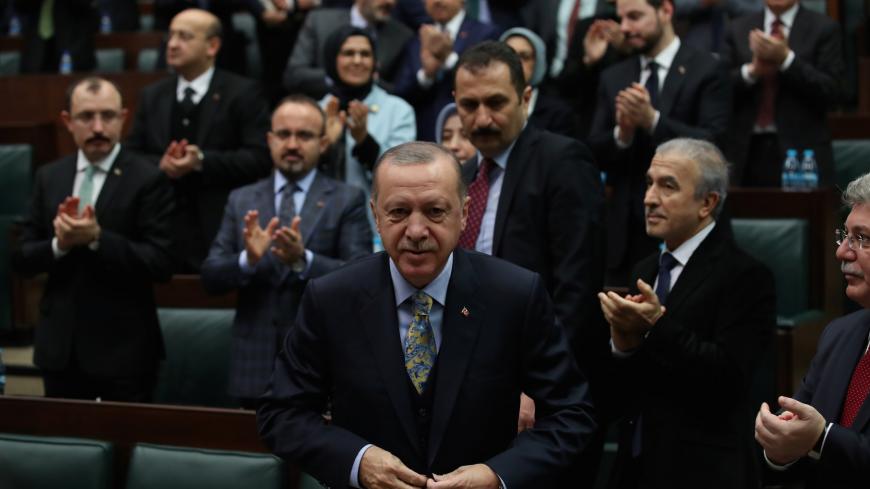 Turkish President Tayyip Erdogan leaves his seat to address members of parliament from his ruling AK Party (AKP) during a meeting at the Turkish parliament in Ankara, Turkey, January 15, 2019. REUTERS/Umit Bektas - RC177363CD90