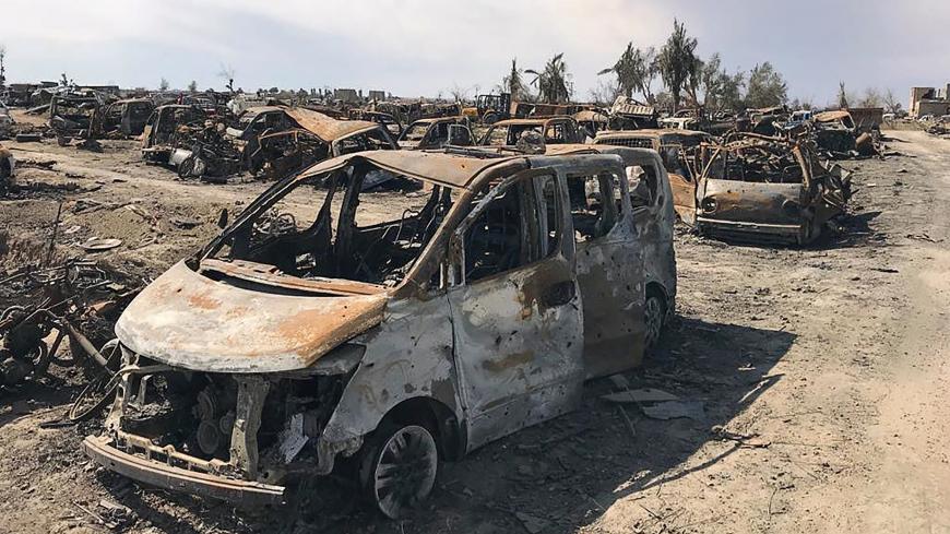 A view of burnt vehicles after the U.S.-backed forces said they had captured Islamic State's last shred of territory, in the village of Baghouz, Deir Al Zor province, Syria, March 23, 2019. REUTERS/Stringer - RC12424ED500