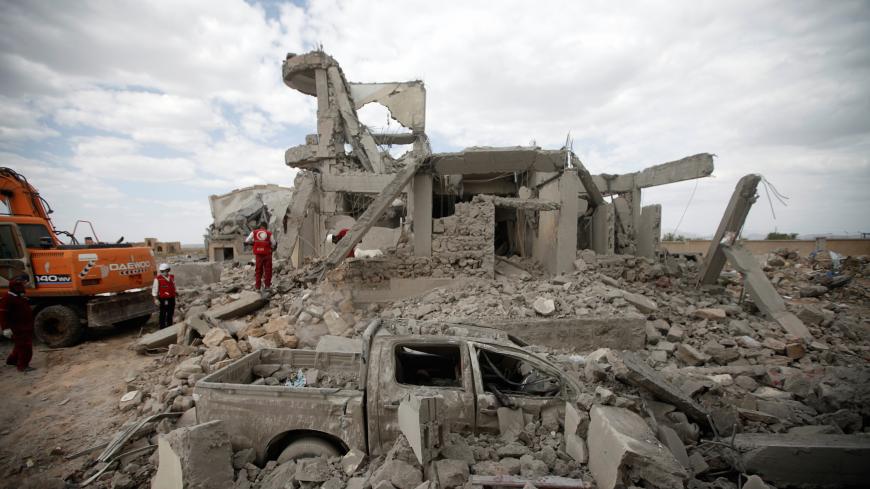 Destroyed car is seen between rubble as Red Crescent medics inspect the site of Saudi-led air strikes on a Houthi detention centre in Dhamar, Yemen, September 1, 2019.  REUTERS/Mohamed al-Sayaghi - RC15DB729000