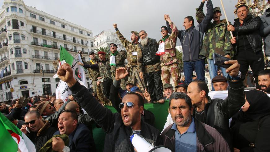 Pro-government supporters take part in a demonstration in favour of the upcoming presidential election in Algiers, Algeria December 9, 2019. REUTERS/Ramzi Boudina - RC2QRD9C73ME