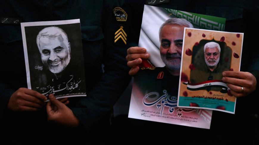 Iranian guards hold a picture of the late Iranian Major-General Qassem Soleimani, during a protest against the killing of Soleimani, head of the elite Quds Force, and Iraqi militia commander Abu Mahdi al-Muhandis, who were killed in an air strike at Baghdad airport, in front of United Nation office in Tehran, Iran January 3, 2020. WANA (West Asia News Agency)/Nazanin Tabatabaee via REUTERS ATTENTION EDITORS - THIS IMAGE HAS BEEN SUPPLIED BY A THIRD PARTY. - RC2L8E9X2X49