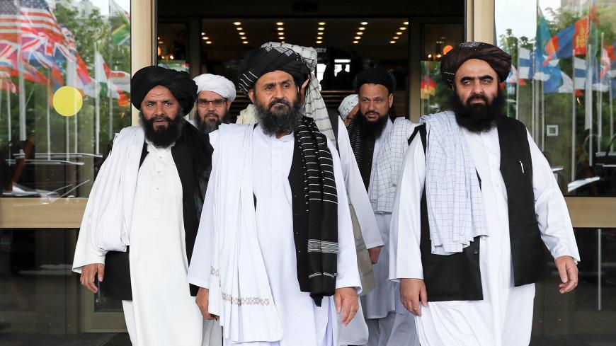 Members of a Taliban delegation, led by chief negotiator Mullah Abdul Ghani Baradar (C, front), leave after peace talks with Afghan senior politicians in Moscow, Russia May 30, 2019. REUTERS/Evgenia Novozhenina - RC17FC2683A0