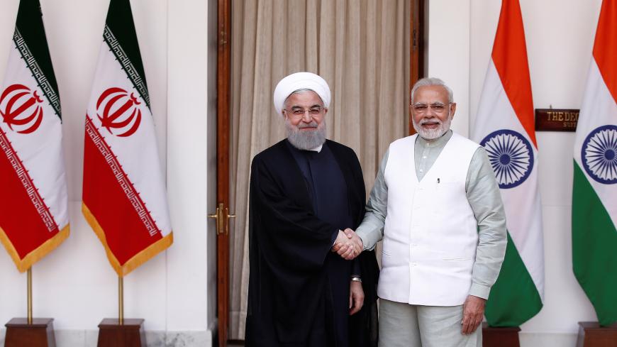 Iranian President Hassan Rouhani shakes hands with India's Prime Minister Narendra Modi (R) during a photo opportunity ahead of their meeting at Hyderabad House in New Delhi, India, February 17, 2018. REUTERS/Adnan Abidi - RC1353D19310